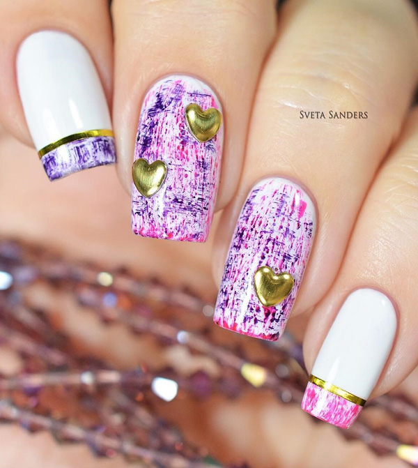 A very pretty paint splatter inspired spring nail art design. Cover your nails with white base color and let loose with the explosion of pink and purple paint splatters on top. Add gold heart shaped embellishments on to for accent.