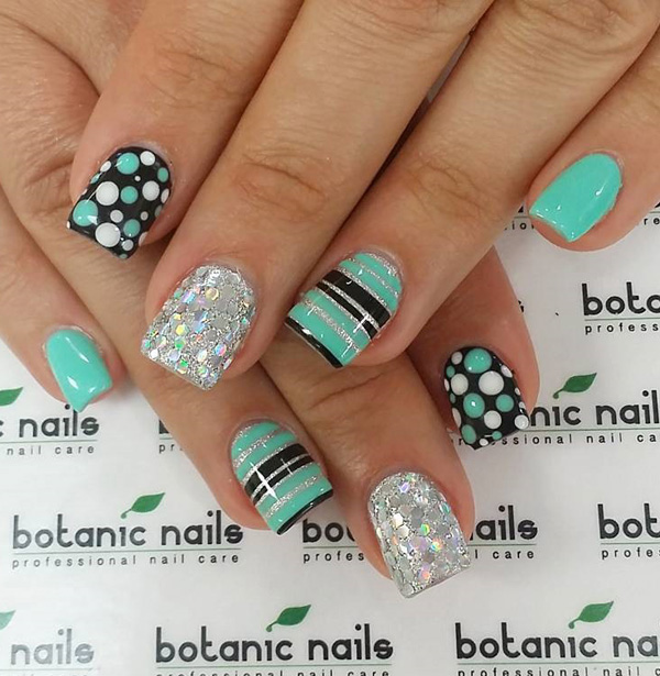 Sea green and black themed spring nail art design. Make sure your nails truly stand out with this quirky design of stripes and polka dots. Bring more attitude to your nails with silver glitter polish.