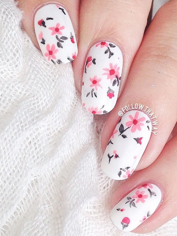 Give your nails a bright spring feel with this flower inspired nail art design. The falling pink flowers look perfect against the white base color of the nails.