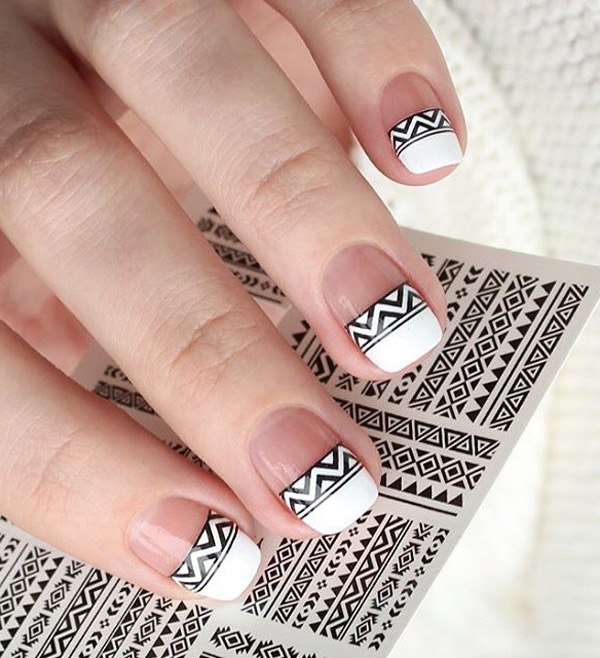 Black and white tribal inspired spring nail art. Make your French tips as interesting as ever with this tribal themed design in black and white nail polish.