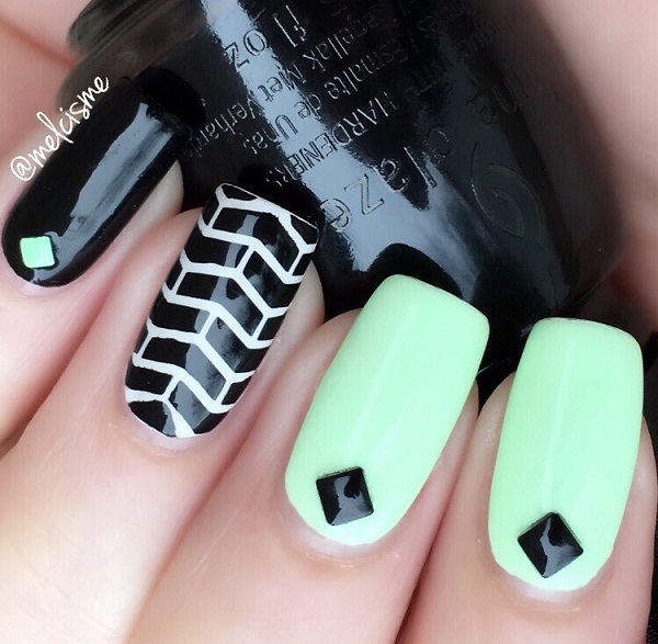 Start your spring strong with this smashing black and white nail art. Paint on black and white matte color as your base and add brick wall designs on top as well as embellishments to complete the effect.