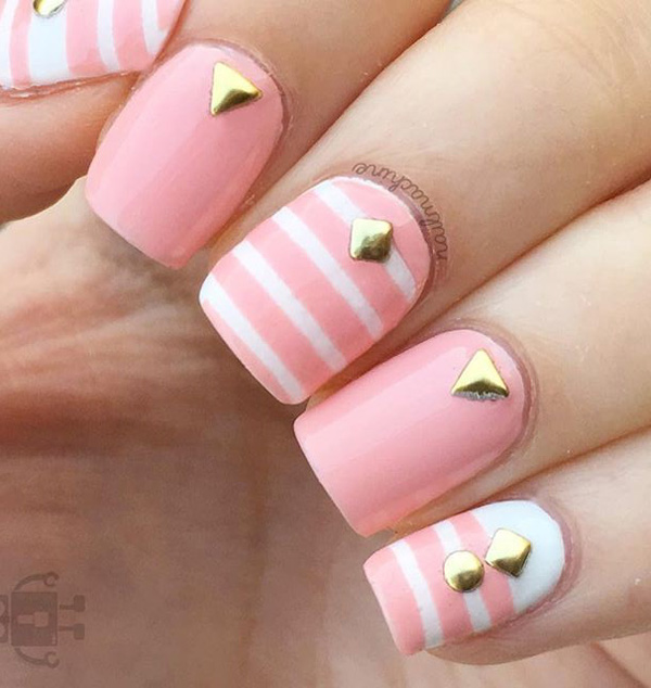 Cute baby pink and white spring nail art design. Give your nails that fresh new look as you welcome the spring. To make the light colors strand out add gold embellishments on top as accent.