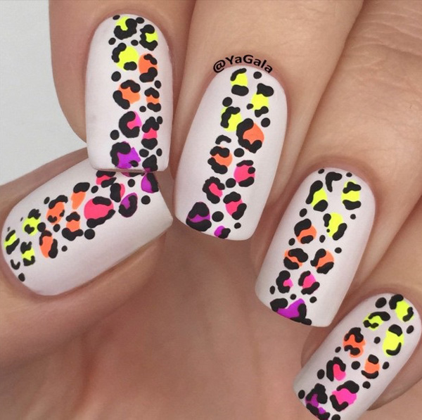 Colorful leopard nail art design. Unlike the other designs this one places the multicolored effect on the prints themselves while maintaining a pure white background.