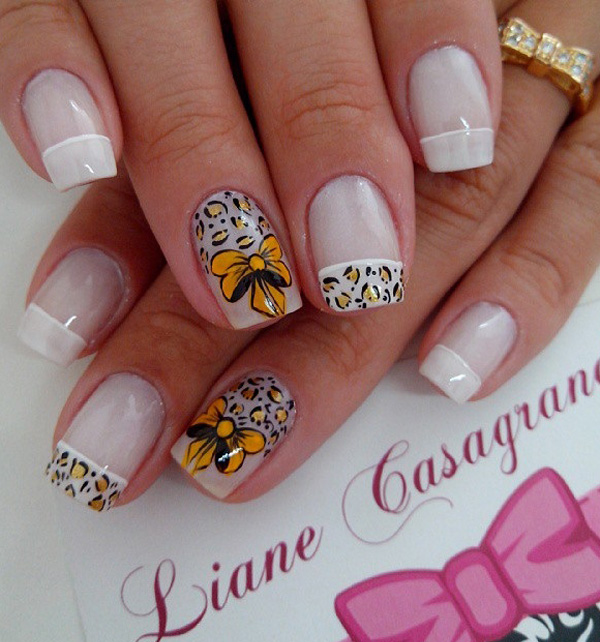 Leopard nail art design in golden rod and white nail polish. The ribbon details for the design look absolutely adorable and goes perfectly with the hand drawn leopard prints around it. The French tips also give the design a uniform and clean appeal.