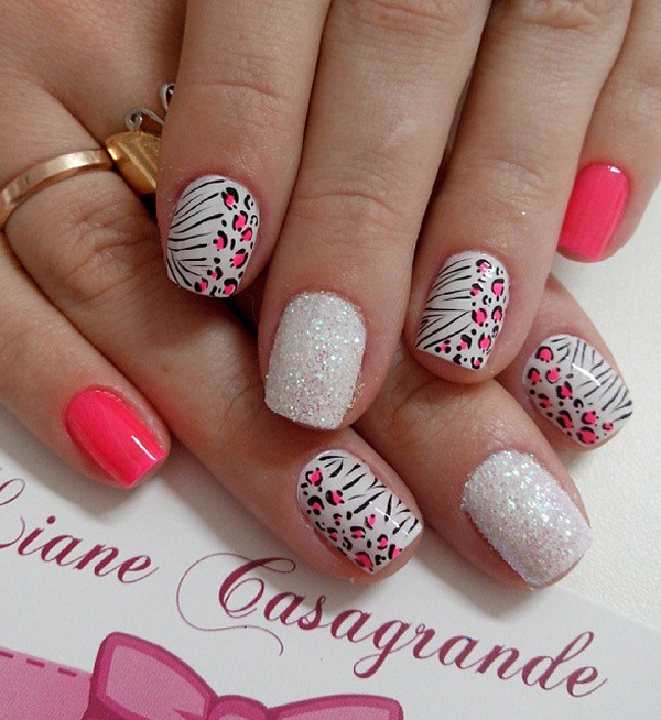 A pretty pink and white leopard nail art design with glitter. Play along with the animal look as the leopard prints are combined with zebra stripes to form this design.