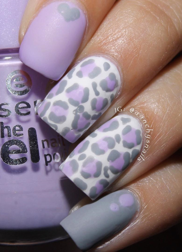 Lavender themed leopard nail art design. The cute and subtle lavender color makes the leopard prints look almost laid back and beautiful. It also blends well with the white background and black outlines.
