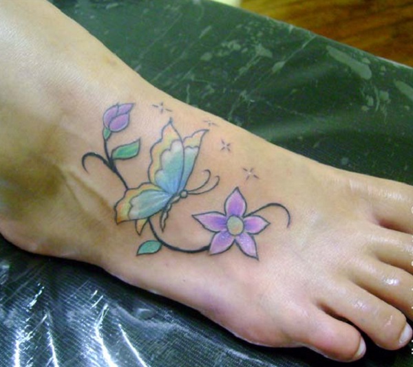 A butterfly with daisy flower tattoo on a foot