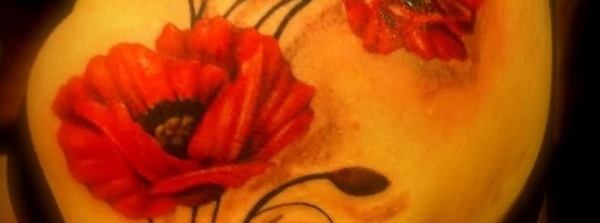 Poppy flowers tattooed on the upper arm