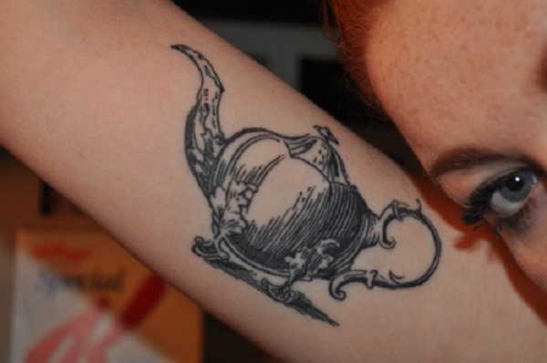 Teacup tattoo on the left side ribcage