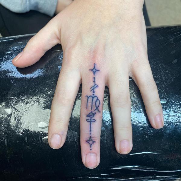 Simple Virgo finger tattoo